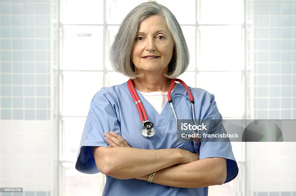 Mujer senior médico brazos cruzados horizontal - Foto de stock de Contemplación libre de derechos