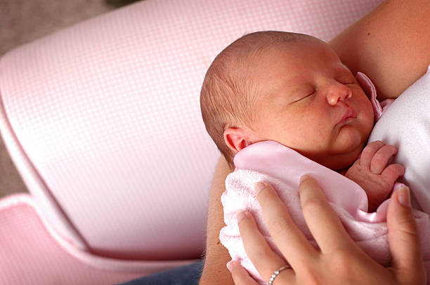 Mother Holding Sleeping Newborn Baby