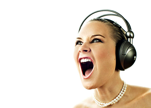 Happy young beautiful girl singing with microphone isolated on white background