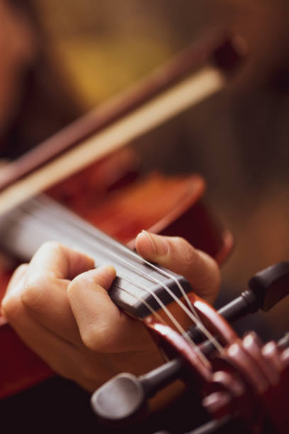 istock Violinist playing violin on outdoors background 1097251370