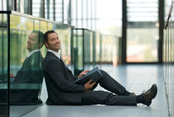 istock Businessman Sitting on Office Floor and Smiling 109725165