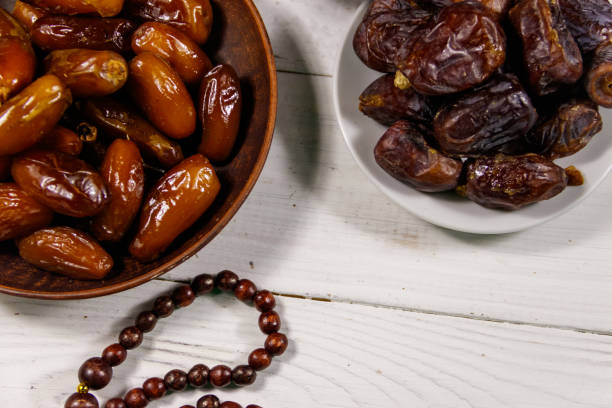 istock Dates fruit and prayer beads on white wooden table. Top view 1097251796