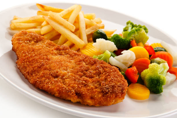 istock Pork chop and vegetables on white background 1097251846