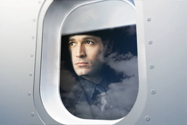 Businessman Looking Out Window of Airplane stock photo