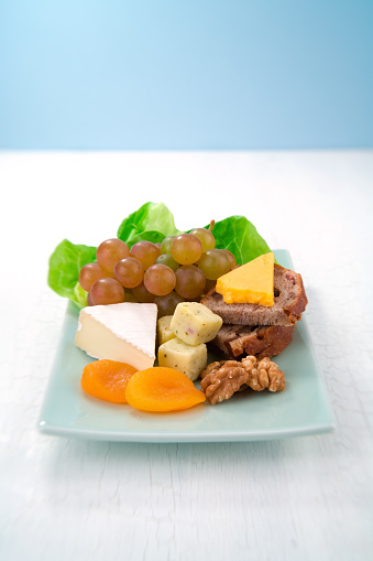 Small sandwiches on a modern gray kitchen table, with salad and meat, table top view with a free space for copy