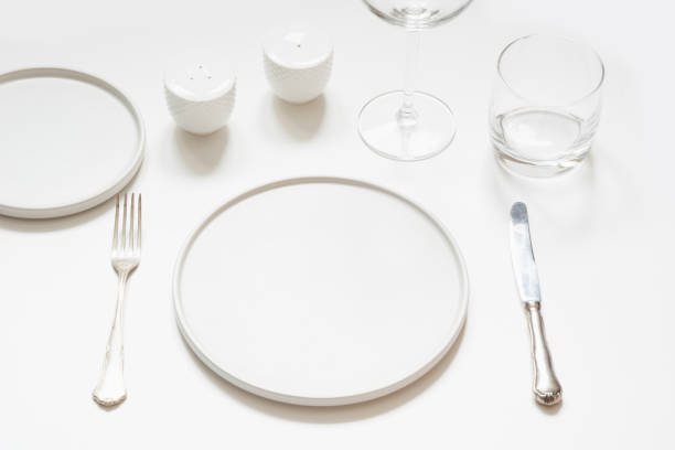 istock Festive modern white table setting. Plates and cutlery on white. 1097254752