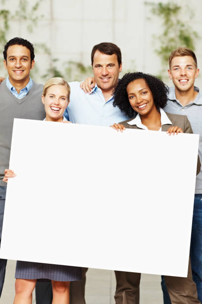 istock Happy multi ethnic business group holding a billboard 109725674
