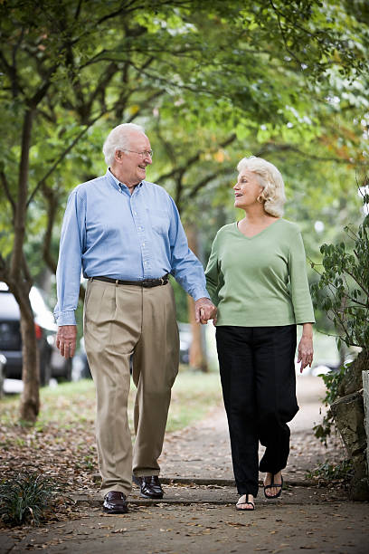 istock Senior Couple Walking Holding Hands 109726374