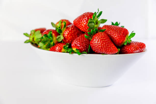istock strawberry on white bowl with white background 1097264288