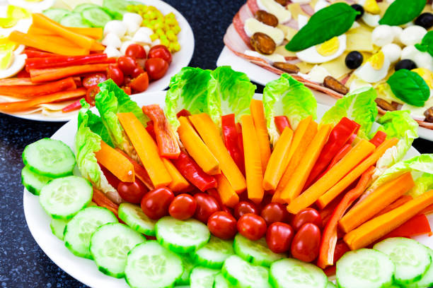 istock Buffet catering food with basil, egg, mozarella, sausage, ham, olive, carrot, tomatoes and others vegatables arangement on table 1097264508