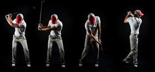 Golf series - Young man golfing, studio shot, isolated on black.