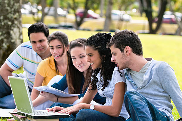 istock Group of Young People Studying in Park Looking at Laptop 109726649