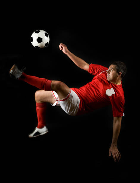 Kick football ball. One Caucasian man, male soccer football player in yellow uniform training isolated on white background. Concept of action, team sport game, energy, vitality. Copy space for ad.