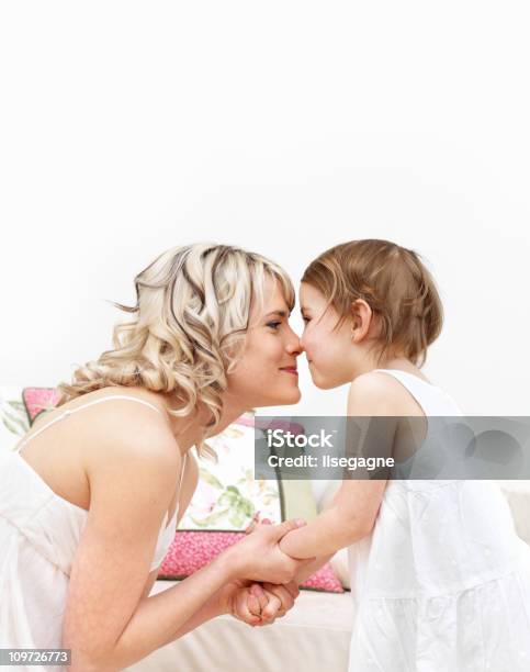 Mother And Daughter Kissing On The Nose Stock Photo - Download Image Now - Mother's Day, 25-29 Years, 4-5 Years