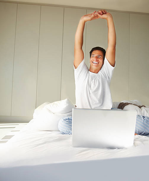 istock Young man stretching his hand relaxing on bed 109726851
