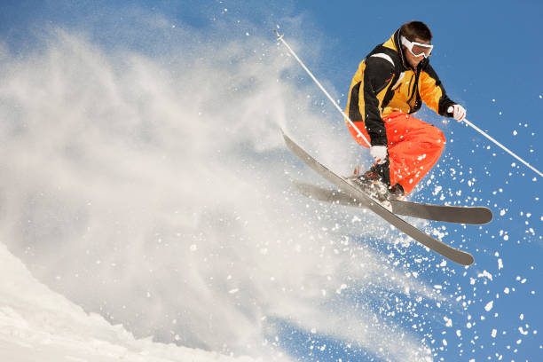 Male skier making extreme jump in powder snow.