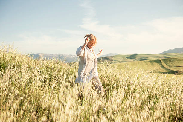 Woman running in grassy field