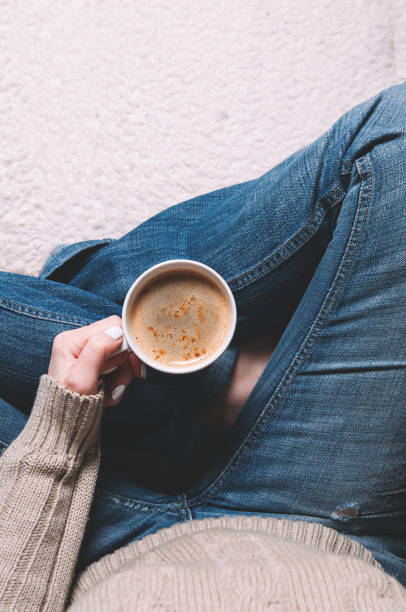 istock Woman holding a Cup of coffee in her hands. Top view 1097271520