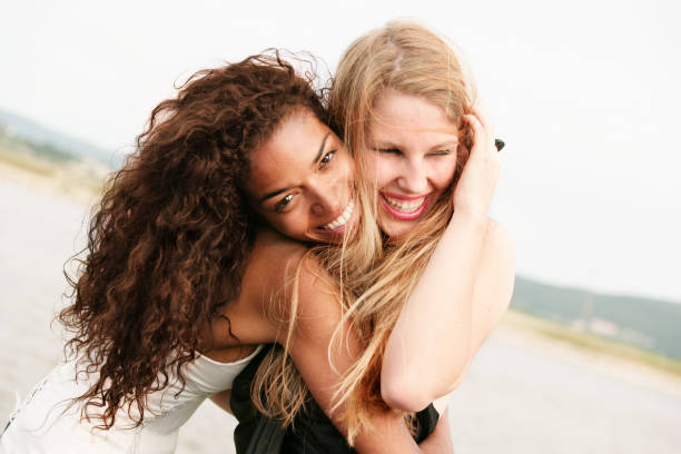istock Young Women Hugging and Laughing Friends 109727232