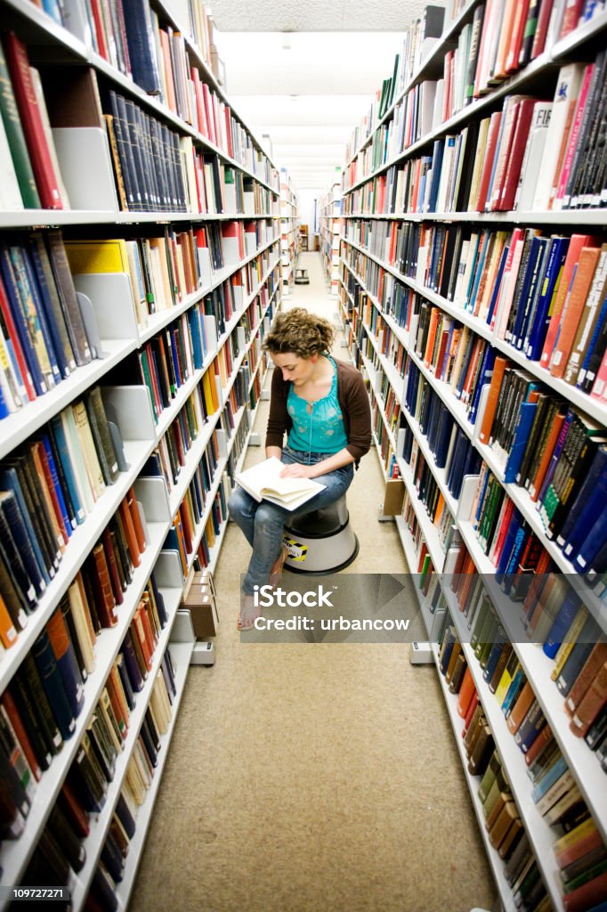 Library study Girl reading in a library University Student Stock Photo