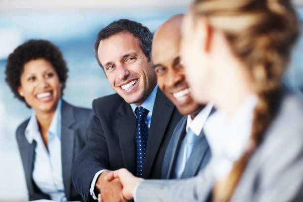 istock Business colleagues smiling and shaking hands 109727317