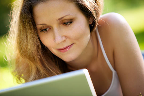 istock Young woman using laptop in park 109727326