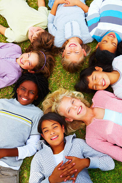 istock High angle view of children lying in a park 109727378