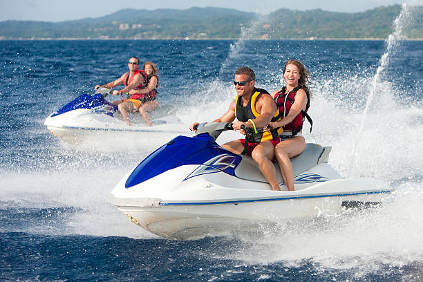 istock Vacation Lifestyles-Friends Riding Jet Skis Together 109727480