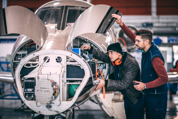 istock Two aircraft mechanics working together on a partially disassembled airplane in a hangar 1097277846