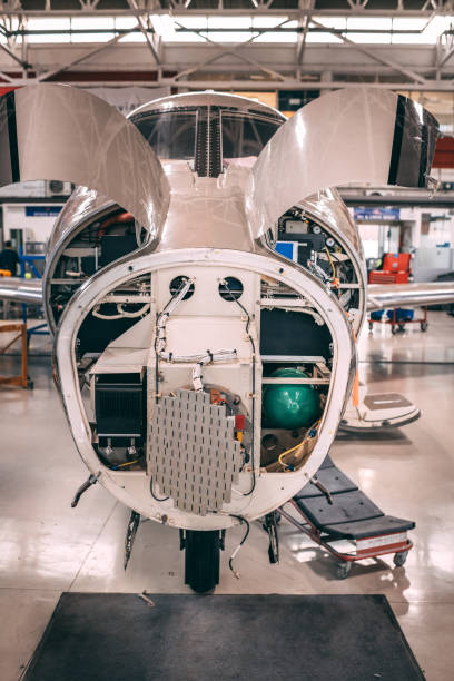 istock Disassembled small airplane with opened motor compartment and a without nose cone in a hangar 1097279454