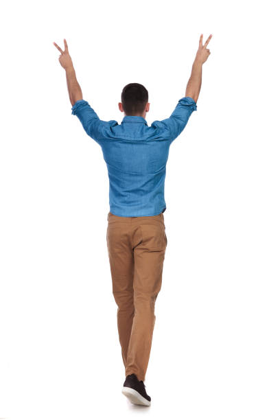 istock rear view of celebrating casual man walking 1097279800