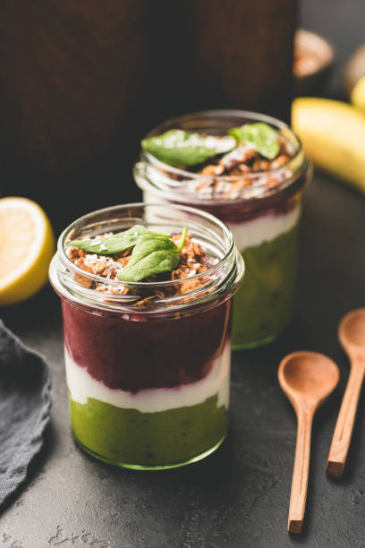 Layered acai avocado smoothie in jar, healthy breakfast