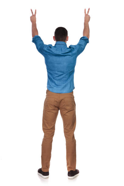 istock back view of casual man celebrating and making peace sign 1097279928