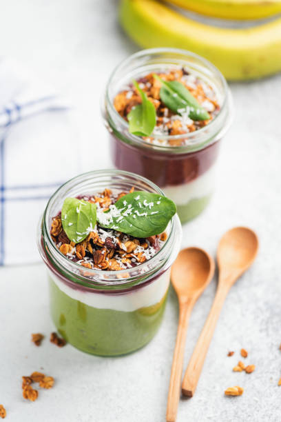 istock Green smoothie in jar topped with granola 1097279932