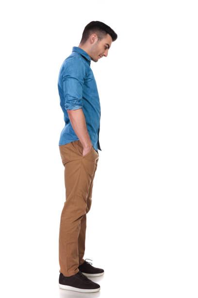 istock relaxed casual man waits in line and looks down 1097280014