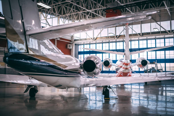 istock Rear view of two small airplanes parked in a hangar 1097280536