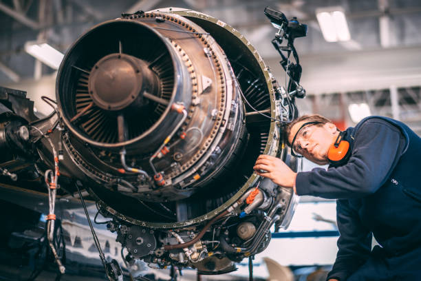istock Aircraft engineer repairing and maintaining a small airplane's jet engine in a maintenance hangar 1097282262