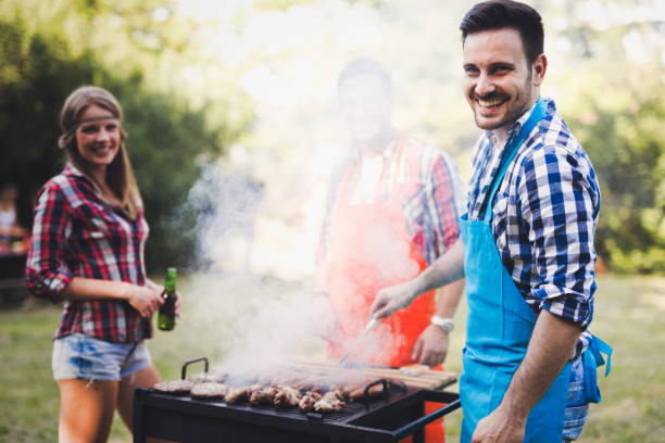 istock Young people grilling outdoors 1097282618