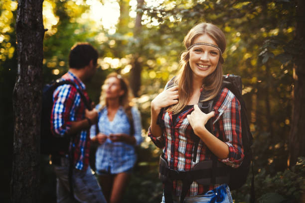 istock Group of people hiking in forest and smiling 1097282802