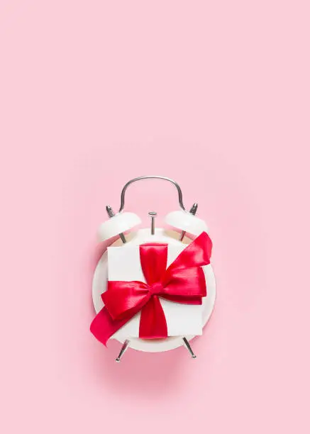 Photo of Valentines day concept pastel minimalis, time to gift on pink background