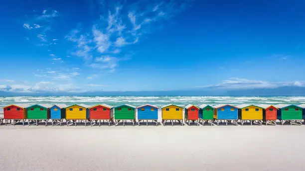 Panorama of the famous colorful beach huts on the white sandy beach of Muizenberg, Cape Town, South Africa.