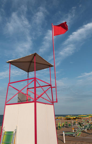 istock turret with red flag on the beach 1097291884