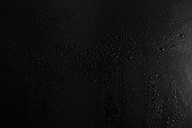 Drops of water on a dark glass texture background