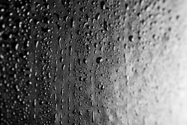 istock Drops of water on a dark glass texture background 1097293520