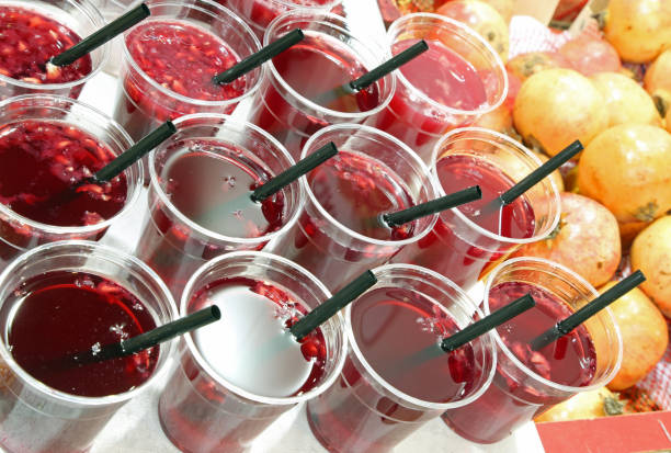istock many plastic glasses with fruit juice of pomegranate 1097296190