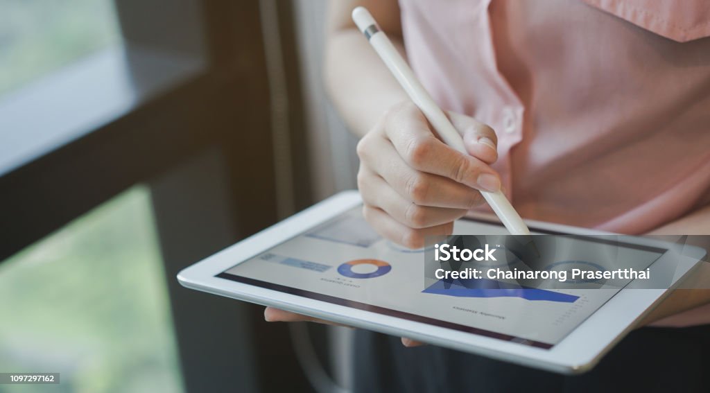 close up on businesswoman manager hand using stylus pen for writing or comment on screen dashboard tablet in meeting situation about company's performance , technology and business strategy concept Dashboard - Vehicle Part Stock Photo