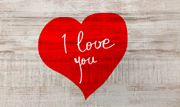 istock Red Heart painted on tree trunk and I love you text 1097298530