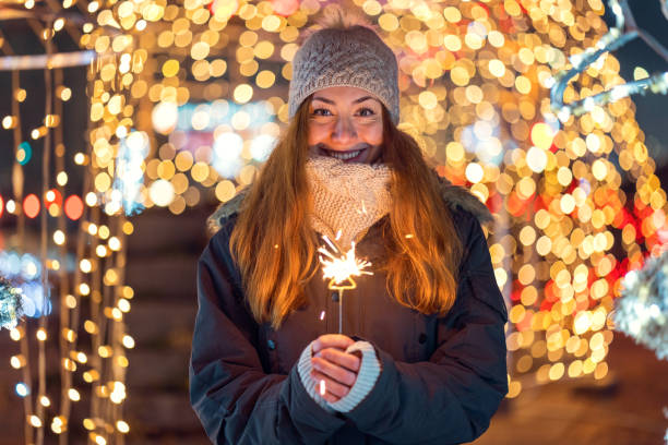 istock Young woman holding burning sparkler 1097302330