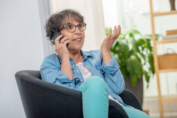 istock an happy middle age woman with glasses using and talking phone 1097304288