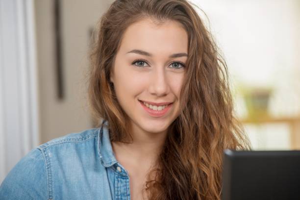 istock young smiling woman with long hair is using a laptop 1097304344